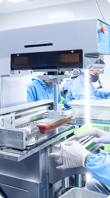 Cleanroom operator working with industrial manufacturing machine