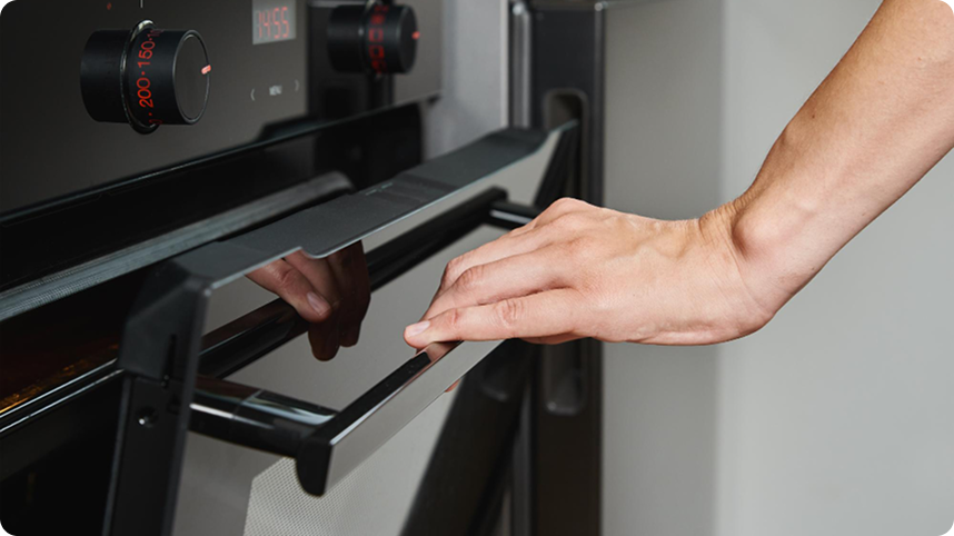 Cleanroom operator interacting with machine control panel