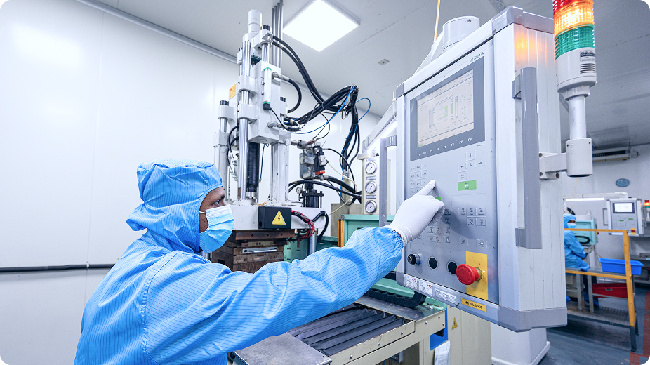Cleanroom operator interacting with machine control panel